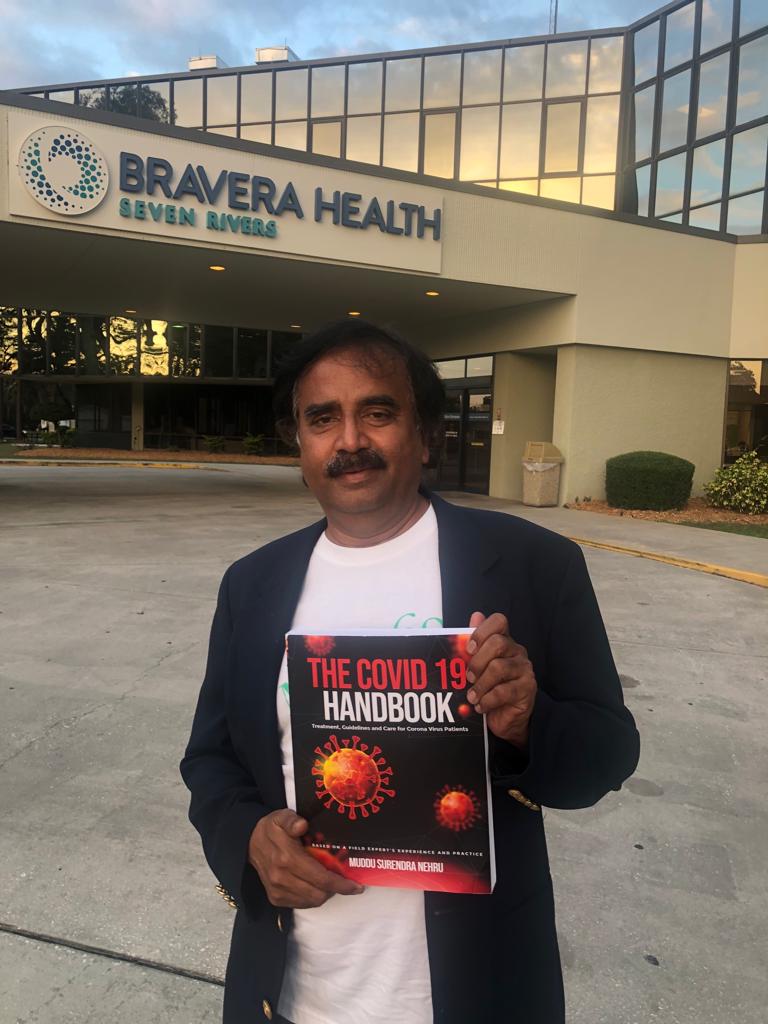 Dr. Muddu Surendra Nehru with The COVID-19 Handbook at Bravera Health USA